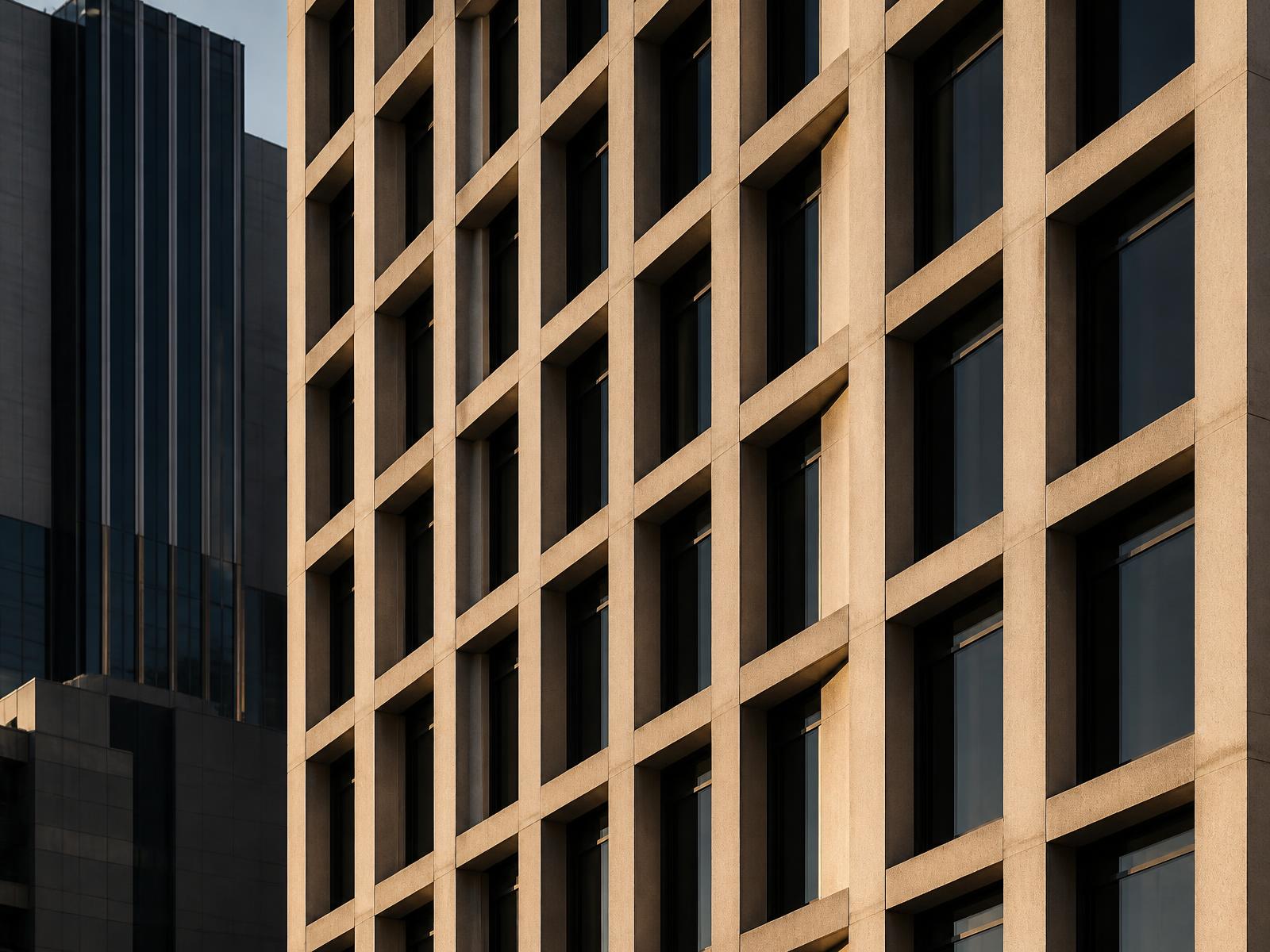 Repeating window grid on a modern downtown Phoenix building facade in warm late-day light
